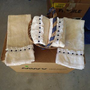 SET OF 4 IVORY HAND TOWELS WITH RUFFLES IN BASKET